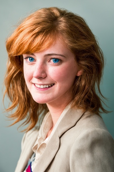 a woman with red hair and blue eyes