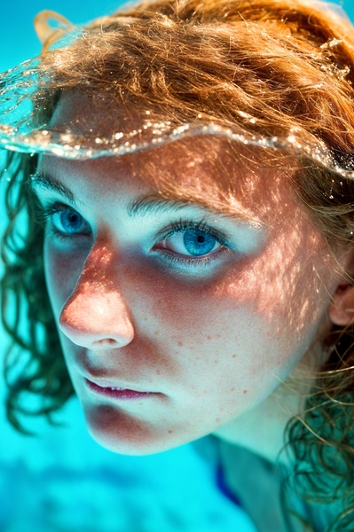 a woman with long hair under water