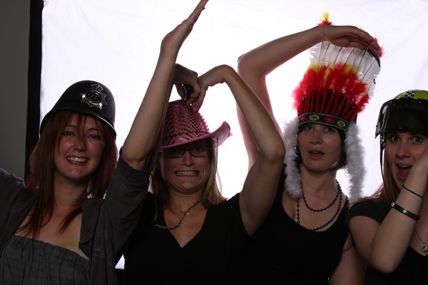 three women wearing hats