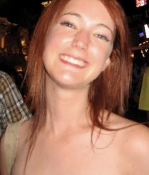 a woman in a white dress posing for the camera