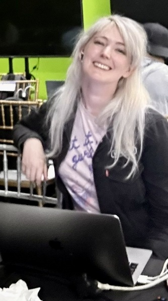 a woman sitting at a table with a laptop