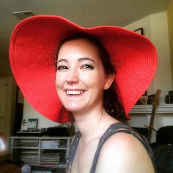 a woman wearing a red hat and smiling