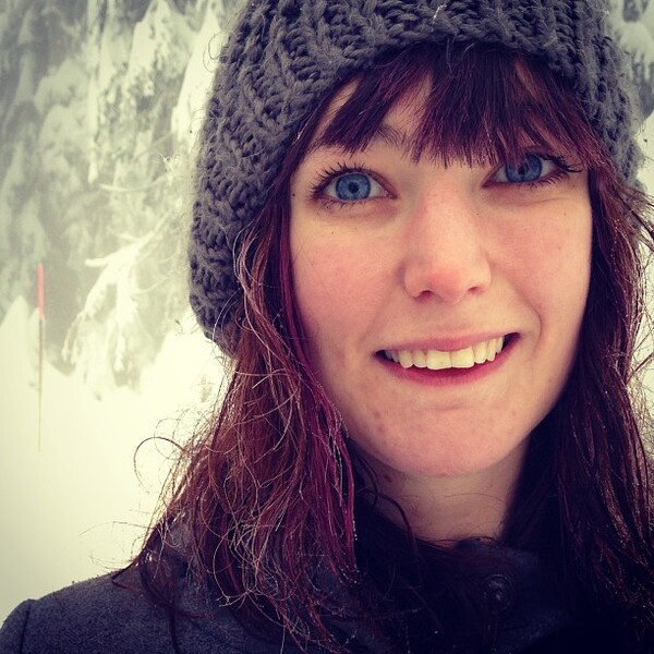 a woman wearing a knit hat with a large smile