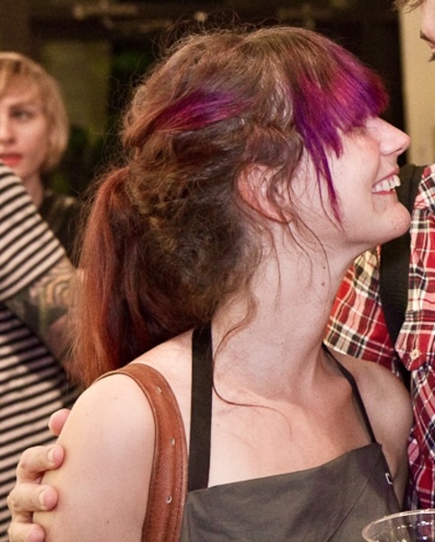 a man and woman are smiling at a table