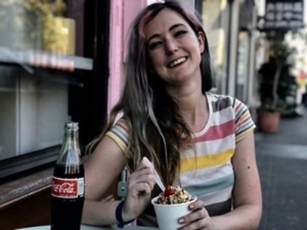 a woman sitting at a table eating food