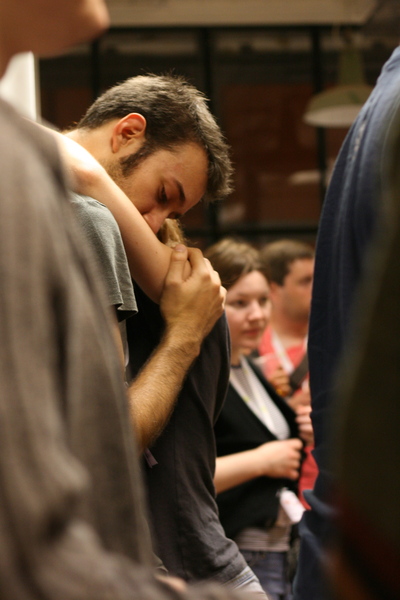 a man is sitting down and holding his head