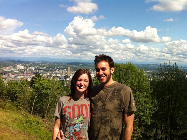 a man and woman standing on a hill