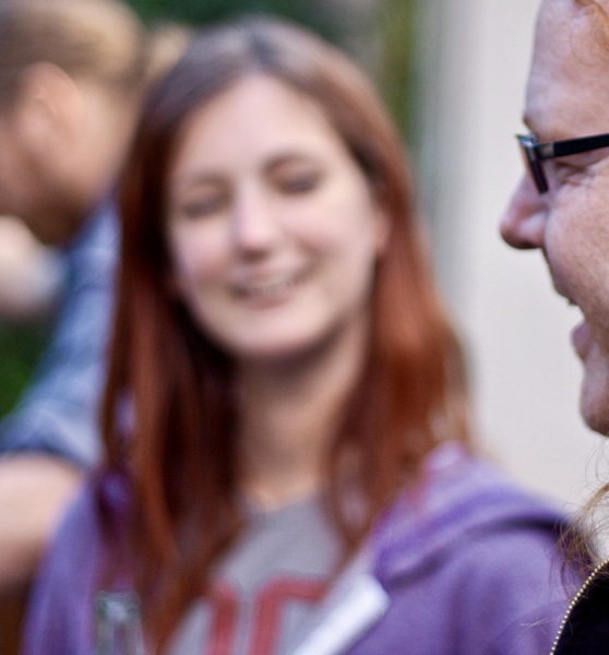 a woman with glasses and a purple shirt