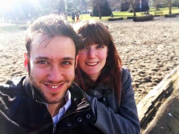 a man and woman are smiling for the camera