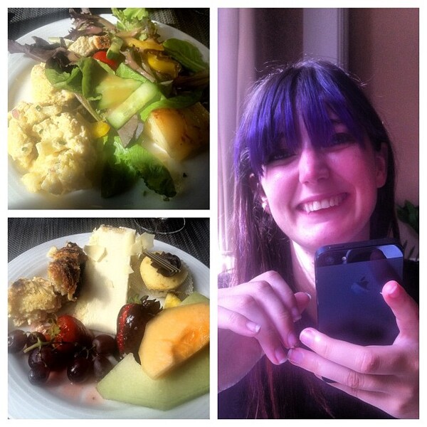 a woman taking a picture of a meal