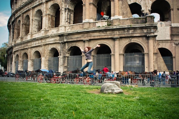 a man is jumping in front of an old building