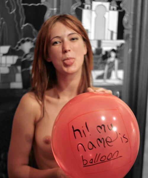 a woman holding a balloon with writing on it