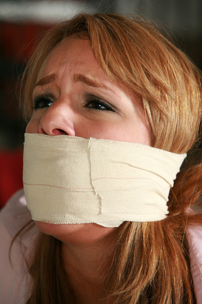 a woman with a bandage on her mouth