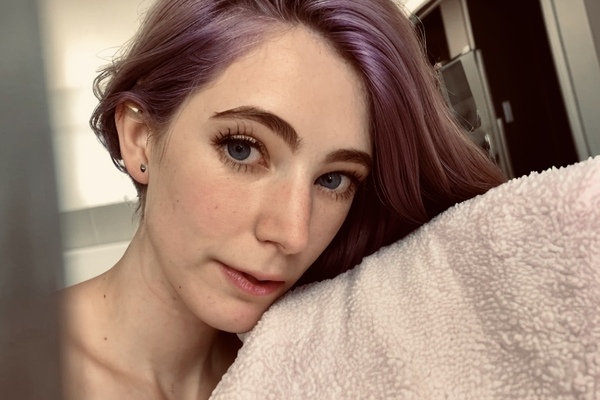 a woman with purple hair and blue eyes