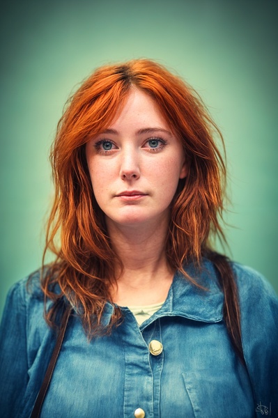 a woman with red hair and blue eyes