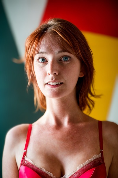 a woman in a red bra top posing for a picture