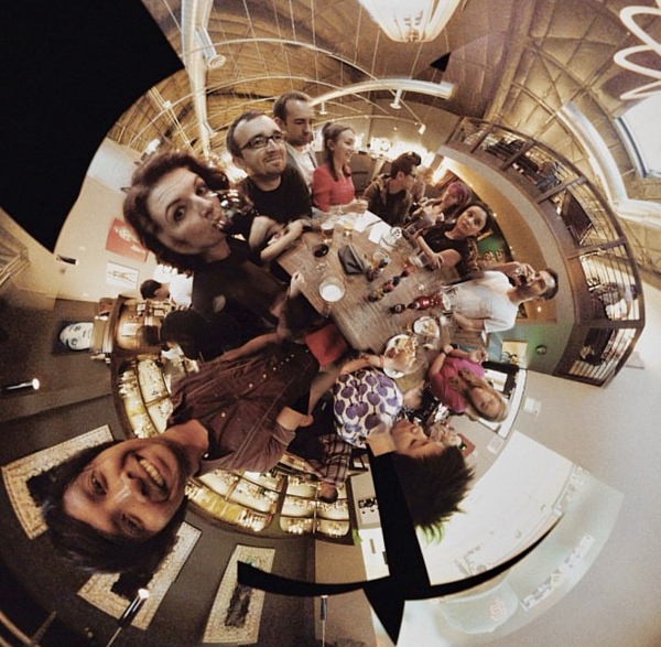 a group of people are gathered in a spiral staircase