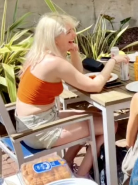 two women sitting at a table eating food