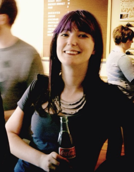 a woman with purple hair and a black shirt