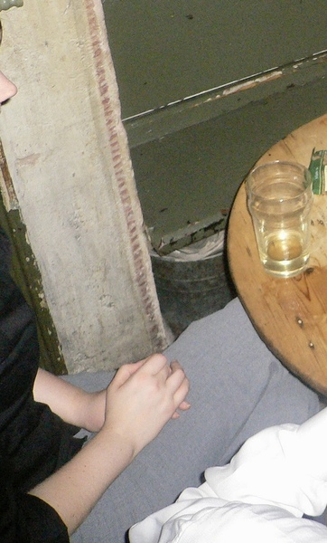 a man sitting at a table with a glass of wine