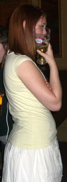 a woman drinking a beer