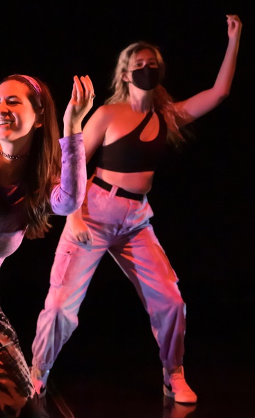 two women are performing a dance routine on stage