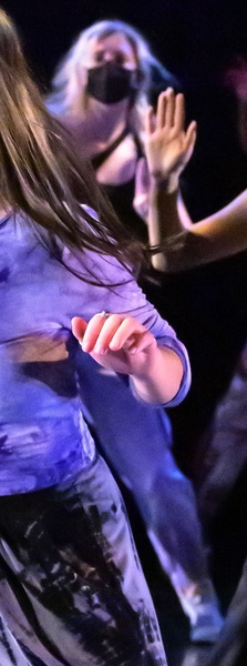 a girl in a blue shirt is dancing