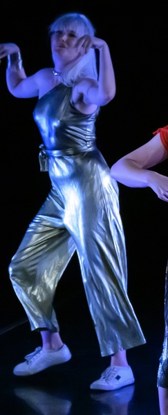 a woman in a silver jumpsuit