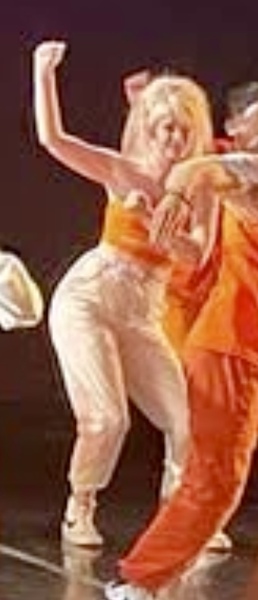 a group of dancers in orange outfits