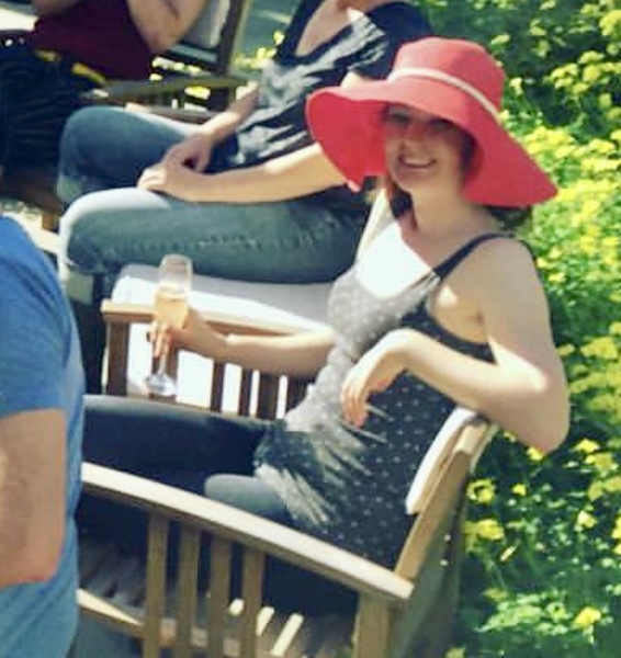 a group of people sitting on a wooden bench