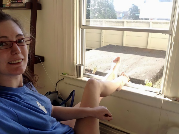 a woman sitting in a chair with a remote control