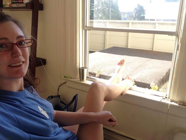 a woman sitting in a chair with a remote control