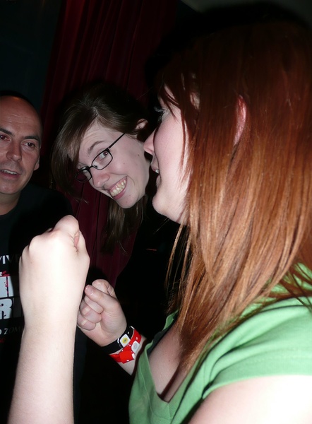 a woman is holding a wii game controller