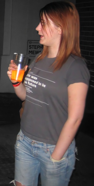 a woman holding a glass of orange juice