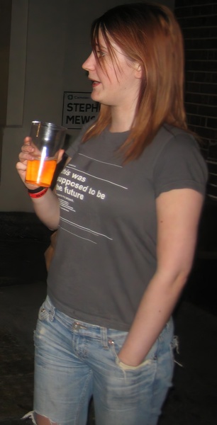 a woman holding a glass of orange juice