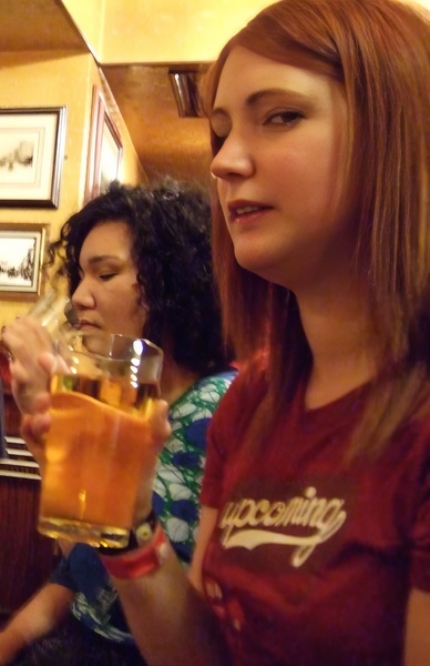 a woman holding a glass of beer