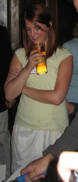 a woman holding a glass of orange juice