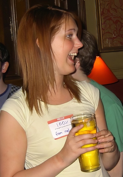 a woman holding a glass of orange juice