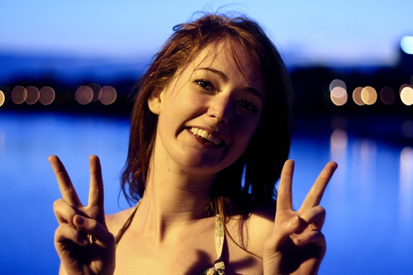 a woman with a peace sign in her hand