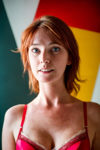 a woman in a red bra top posing for a picture