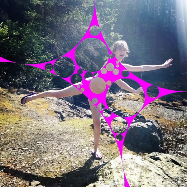 a woman standing on a rock in the woods