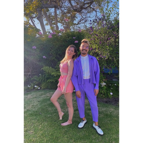 a man and woman in purple suits posing for a photo