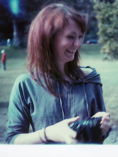 a woman holding a camera in her hands