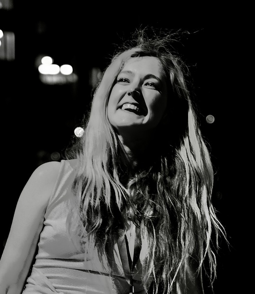 a woman with long hair and a white shirt