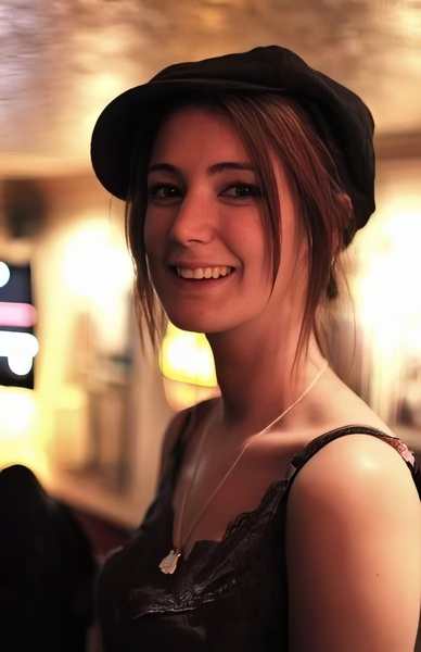 a woman with a hat and a smile