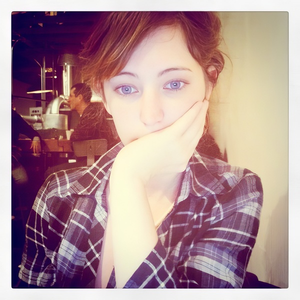 a woman with a blue eye and a plaid shirt