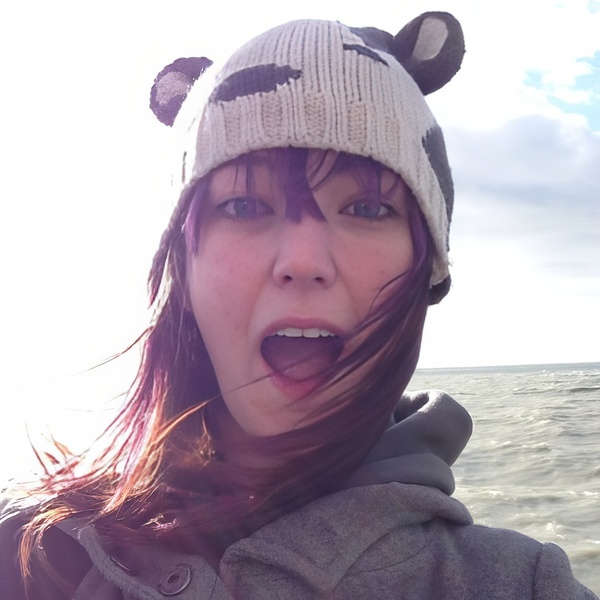 a woman in a hat and jacket on a boat