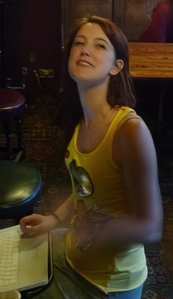 a woman sitting at a table with a keyboard