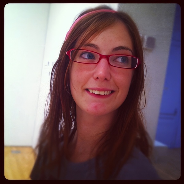 a woman with glasses and a pink headband