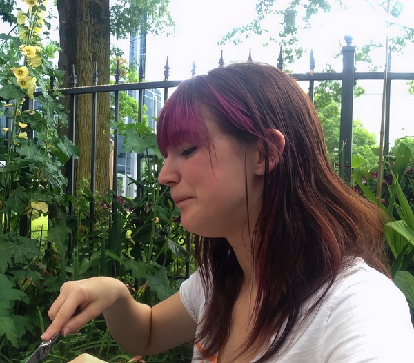 a woman is eating a sandwich with a fork  —
“gt
wat
~